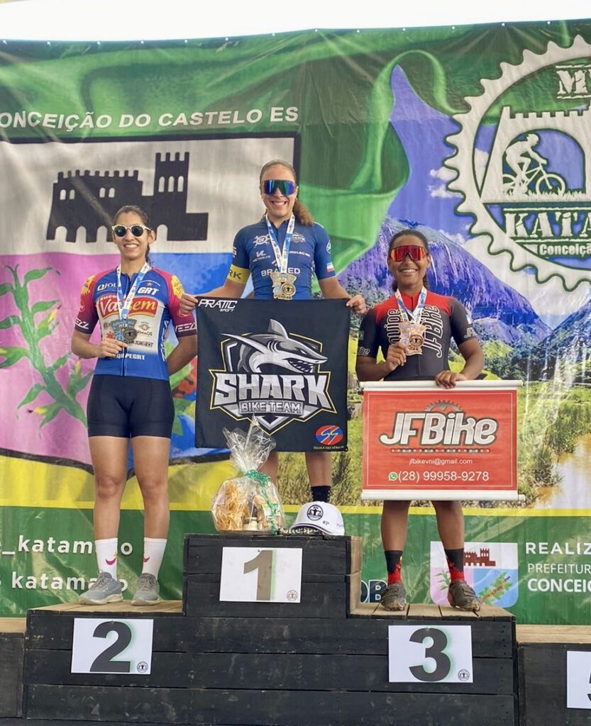 women's podium with shark team with Isa Oliveira winning